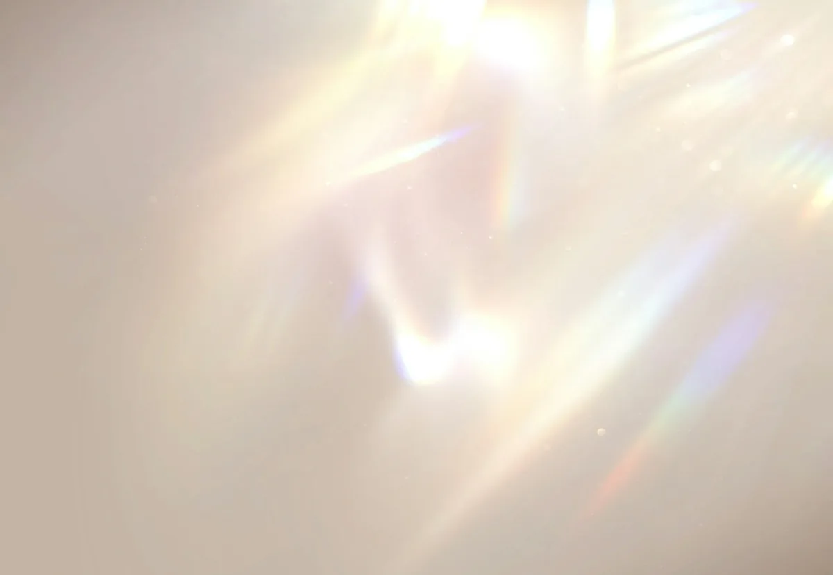 Abstract image of sun rays reflecting on skin cells.